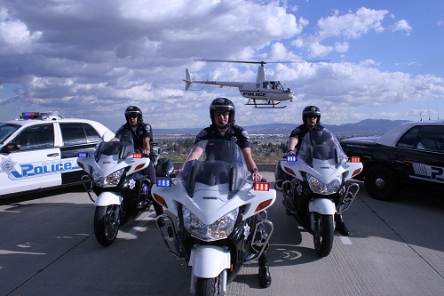 Three police officers driving bike on the road